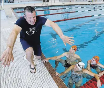  ?? CLIFFORD SKARSTEDT EXAMINER ?? Trent Swim Club coach Ken Crockower talks to swimmers Evan Feicic,16, Rachel Chayer, 14, and Mackenzie Garside, 13, on Wednesday at Trent University pool. The swimmers will be heading to the junior national meet.