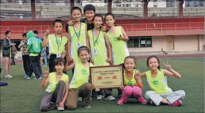  ??  ?? Top: Wang Hongxu (center, back) poses for a photo with his school team in a track-and-field meet in Dadukou district, Chongqing, in 2012.