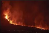  ?? SAUL SANTOS — THE ASSOCIATED PRESS ?? Lava flows from a volcano on the Canary island of La Palma, Spain, in the early hours of Tuesday.