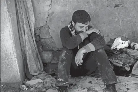  ?? FELIPE DANA, FILE/AP PHOTO ?? In this March 24 file photo, Ahmed Pesher cries next to the destroyed houses where he says 23 members of his family were killed during fighting between Iraqi security forces and the Islamic State on the western side of Mosul, Iraq. Iraqis in the...