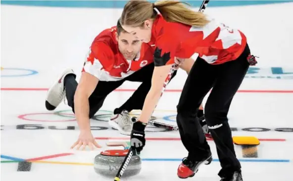  ??  ?? Kaitlyn Lawes and John Morris get down to business in the mixed doubles gold- medal game against Switzerlan­d at the Olympic Winter Games in Gangneung, South Korea, on Tuesday. The Canadian duo dominated, winning 10- 3. Nathan Denette/ The Canadian Press