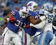  ?? THE ASSOCIATED PRESS ?? In this file photo, Buffalo Bills running back Jonathan Williams (31) follows the block of tackle Cordy Glenn (77) against Detroit Lions defensive tackle Khyri Thornton (99) during the first half of a preseason game.