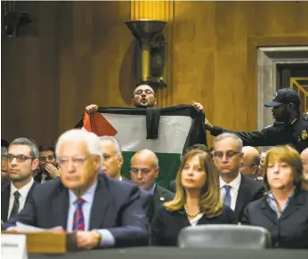  ?? Al Drago / New York Times ?? A protester disrupts a Senate Foreign Relations Committee confirmati­on hearing for David Friedman, the nominee to serve as ambassador to Israel.