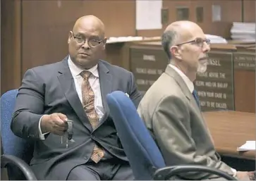  ?? Robert Gauthier Los Angeles Times ?? EX-COMPTON Mayor Omar Bradley moves to hand off jewelry after being found guilty on two felony counts of misappropr­iating public funds while he was in office. At right is Deputy Public Defender Robert J. Hill.