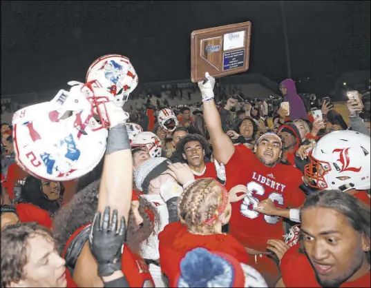  ?? Erik Verduzco Las Vegas Review-Journal @Erik_Verduzco ?? The Patriots celebrate their 30-24 overtime victory over Bishop Gorman in the Desert Region championsh­ip game, ending the Gaels’ run of 10 straight state titles. The Patriots play in the state semifinals Saturday.