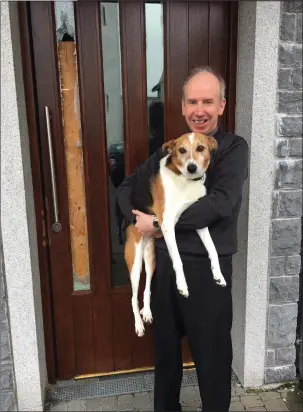  ??  ?? Parish Priest of St Anne’s Fr Pat Lombard with parish dog Penny outside one of the damaged doors at St Anne’s. ABOVE: Thieves entered the doors on the right to the Family room.