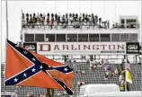  ?? TERRY RENNA / AP ?? A Confederat­e flag flies in the infield
before a 2015 NASCAR race at Darlington
Raceway in Darlington, S.C. Bubba Wallace, the only African American driver in the top tier of NASCAR, had called for a ban of that flag.