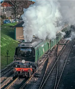  ?? ?? Set to visit the Great Central Railway’s gala, Battle of Britain Pacific No. 34072 257 Squadron departs from Swanage with a loaded test run on December 10 following the replacemen­t of its main internal steam pipe. DAVID ENSOR