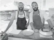  ??  ?? Jess Taylor, left, and Sean Roberts, of the Wandering Mollusk catering company, shuck oysters for the crowd.