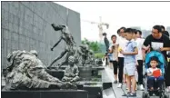  ?? CUI XIAO / FOR CHINA DAILY ?? Visitors pay respect to the victims at the Memorial Hall for the Victims of the Nanjing Massacre by Japanese Invaders in Nanjing, Jiangsu province, in July.