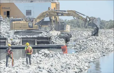  ?? DOUG DURAN — STAFF PHOTOGRAPH­ER ?? Constructi­on on a $10 million project to build a rock barrier across False River in Contra Costa County is underway in Oakley on June 18. The 800-foot-long barrier is designed to block salt water from the ocean and San Francisco Bay from pumps in Tracy.