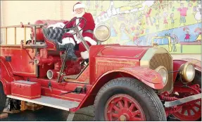  ?? Marc Hayot/Herald-Leader ?? Santa sits in Siloam Springs Fire Department’s vintage fire engine waiting for children to jump in the back for socially distanced photos during Heritage League’s Breakfast with Santa earlier this month.