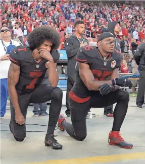  ?? KIRBY LEE/USA TODAY SPORTS ?? Colin Kaepernick (7) and Eric Reid (35) kneel before a 49ers game Oct. 6, 2016, in protest during the national anthem.