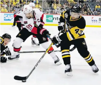  ?? GENE PUSKAR, THE ASSOCIATED PRESS ?? Penguins forward Conor Sheary tries to wheel away from Senators defenceman Erik Karlsson during the second period of Game 2 in Pittsburgh on Monday.