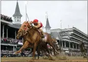  ?? JEFF ROBERSON — THE ASSOCIATE PRESS ?? Rich Strike, with Sonny Leon aboard, crosses the finish line to win the 148th running of the Kentucky Derby horse race at Churchill Downs Saturday, in Louisville, Ky.