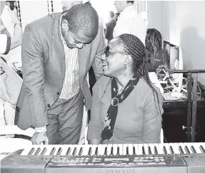  ??  ?? Symone Thomas, music teacher at Oracabessa Primary, shares words with Floyd Green, state minister for education, during his recent visit to the school.