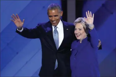  ?? J. SCOTT APPLEWHITE — ASSOCIATED PRESS FILE ?? President Barack Obama and Hillary Clinton wave to delegates after Obama’s speech at the Democratic National Convention in Philadelph­ia in July.