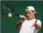  ?? Alastair Grant / Associated Press ?? Tim van Rijthoven returns the ball to Nikoloz Basilashvi­li during the third round at Wimbledon on Friday.