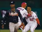  ?? ALEX BRANDON — THE ASSOCIATED PRESS ?? Washington’s Juan Soto, right, and Trea Turner celebrate behind Atlanta second baseman Ozzie Albies after Soto hit a winning single in the ninth inning in Washington.