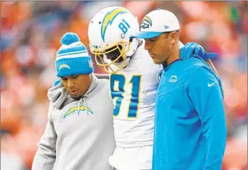  ?? Matthew Stockman Getty Images ?? CHARGERS RECEIVER Mike Williams is helped off Empower Field because of a back injury. Brandon Staley played Williams and other starters in the meaningles­s game, and now it could haunt them in the playoffs.