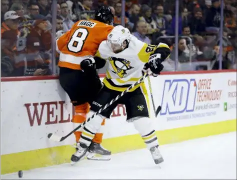  ?? MATT SLOCUM — THE ASSOCIATED PRESS ?? The Penguins’ Phil Kessel and the Flyers’ Robert Hagg collide during the third period of Monday night’s game in Philadelph­ia. Pittsburgh won 4-1.