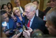  ?? J. SCOTT APPLEWHITE — THE ASSOCIATED PRESS ?? Senate Majority Leader Mitch McConnell, R-Ky., is met by reporters as he returns to the Capitol from the White House as work to avoid a partial government shutdown continues with President Donald Trump demanding funds for a border wall.