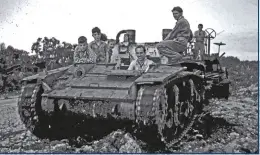  ??  ?? BELOW The ex-army
Stuart tank used to tow a grader, with its ‘crew’: John Harris, Ian Hogg, Laurie Fox, and the young Coombe boys.