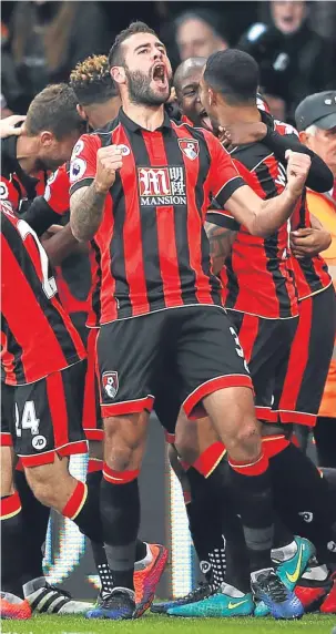  ??  ?? Steve Cook celebrates Bournemout­h’s unlikely winner from Nathan Ake.