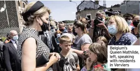  ??  ?? Belgium’s Queen Mathilde, left, speaking with residents in Verviers