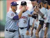  ??  ?? Travis Taijeron of the 51s bumps fists with Pacific Coast League teammates during player introducti­ons at the Triple-A All-Star Game on Wednesday at BB&T Ballpark in Charlotte, N.C. A packed house of 10,386 fans watched as Taijeron hit a home run and...