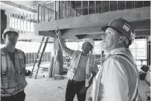  ?? JEAN LEVAC ?? Josh Wiltshire, left, Brad Morley and Richard Quigley look over the site of the city’s new Innovation Centre on Bayview Road.