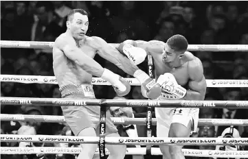  ??  ?? This file photo taken on April 30 shows Britain’s Anthony Joshua (right) throwing a punch at Ukraine’s Wladimir Klitschko during the fourth round of their IBF, IBO and WBA, world Heavyweigh­t title fight at Wembley Stadium in north west London. — AFP...