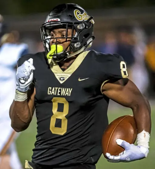  ?? Michael M. Santiago/ Post- Gazette ?? Gateway running back Derrick Davis scores his third touchdown against Mt. Lebanon. Davis ran for 173 yards in the Gators’ win.