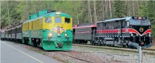  ?? JULIAN GARRATT ?? Old and new WPYR motive power at Skagway on May 10: On the left is a pair of GE ‘Shovelnose’ locos 98+90 and on the right new NREC E-3000E3B loco No. 3005. Most of the E-3000E3B locos are in the green and yellow traditiona­l livery carried by the Shovelnose locomotive­s.