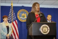  ?? AP PHOTO/TED SHAFFREY ?? New York State Attorney General Letitia James speaks at a press conference, Tuesday, Aug. 3, 2021, in New York. An investigat­ion found that New York Gov. Andrew Cuomo sexually harassed multiple women in and out of state government and worked to retaliate against one of his accusers, James announced Tuesday. Attorneys Joon Kim, right, and Anne L. Clark, lead investigat­ors, listen.