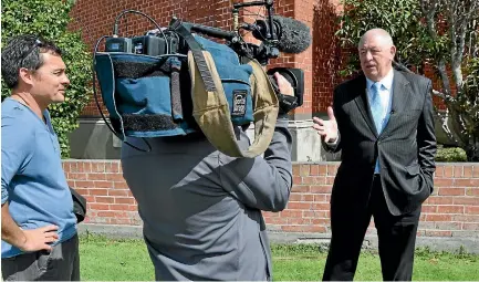  ??  ?? Former Police Ten 7 presenter Graham Bell is filmed by director Les Dawson, left, and cameraman Chris Brokensha.