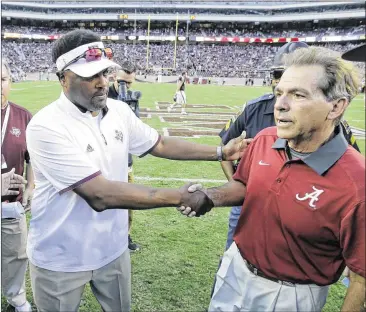  ?? ERIC GAY / AP ?? Texas A&M coach Kevin Sumlin (left), greeting Alabama coach Nick Saban after the Tide’s win last week in College Station, and the Aggies are still far away from matching the Crimson Tide’s success on the field.