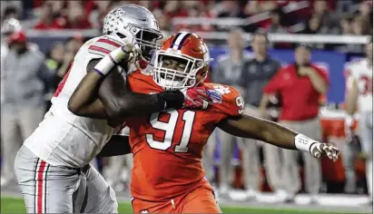  ?? RICK SCUTERI / ASSOCIATED PRESS 2016 ?? Although losing some players early to the NFL, Clemson coach Dabo Swinney will welcome back his entire starting defensive line for the 2018 season, including standout end Austin Bryant (91).