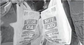  ?? Elise Amendola / Associated Press file ?? Walgreens Boots Alliance clinched regulatory approval for a deal to buy a large number of Rite Aid Corp. stores after two years of failed attempts.