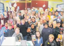  ??  ?? (Left): Huia Range Year 4-6 students show their books received for completing their Winter Warmers Reading Challenge.