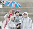  ??  ?? Tourists in Trafalgar Square this week as rain returned to Britain after the dry spell