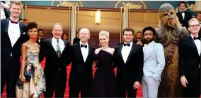  ?? AP PHOTO BY JOEL C RYAN ?? Actors Joonas Suotamo, from left, Thandie Newton, Woody Harrelson, director Ron Howard, actress Emilia Clarke, actor Alden Ehrenreich, actor Donald Glover, a person dressed as the character Chewbacca and actor Paul Bettany pose for photograph­ers upon...