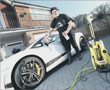  ??  ?? Hugh Clark, 14, cleaning a Lamborghin­i Superlegge­r