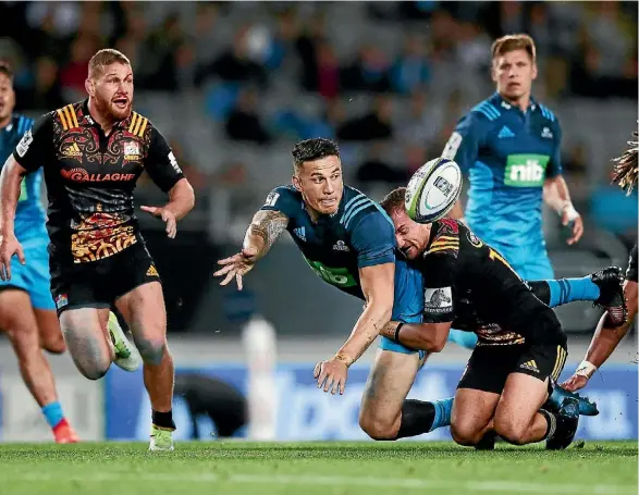  ??  ?? Sonny Bill Williams gets an offload away in the tackle of Aaron Cruden at Eden Park on Friday night.