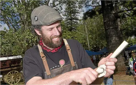  ?? Photos: Nev Madsen ?? HANDS-ON: Spoonmaker and woodworker Pete Trott works his magic on some sycamore at the Lost Trades Fair at Cobb+Co Museum.