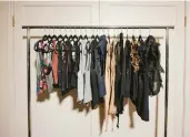  ?? MAGGIE SHANNON/THE NEW YORK TIMES ?? Stylist Chellie Carlson says she likes to use a rolling rack to hang each category of clothing as she goes through the closet.