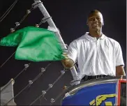  ?? ASSOCIATED PRESS ?? Charlotte Bobcats ownerMicha­el Jordan practices waving the green flag before a race at Charlotte Motor Speedway in 2010. Denny Hamlin is starting his ownrace teamin partnershi­p with Jordan.