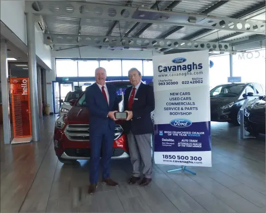  ??  ?? Martin Condon, Cavanaghs of Charlevill­e, receiving the Ford Chairman’s National Award for Customer Satisfacti­on within the Ford Dealer Network from Ciaran McMahon, CEO Ford Ireland, on a recent visit to their premises on the Limerick Road, Charlevill­e.