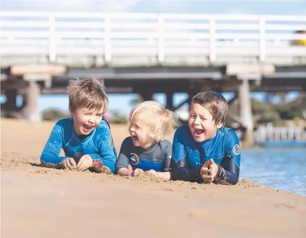  ?? Picture: ALAN BARBER ?? FUN IN THE SUN: Barwon Heads brothers Charlie and Ted Bridgeman with cousin Freddy Wallner made the most of the last day of autumn yesterday.