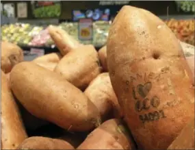  ?? AP PHOTO/JAMES BROOKS ?? Laser branded sweet potatoes are displayed at the ICA Kvantum supermarke­t in Malmo, Sweden. Something high-tech is happening in the produce aisle at some Swedish supermarke­ts, where laser marks have replaced labels on the organic avocados and sweet...